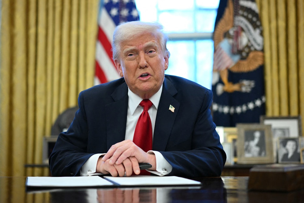 President Donald Trump sits in the Oval Office as he announces tariffs on auto imports.