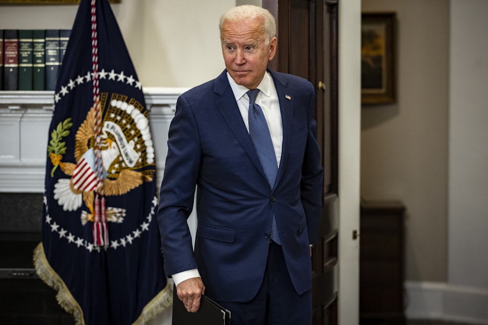 President Joe Biden enters the Roosevelt Room to address reporters.