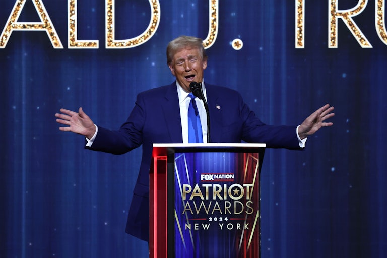 Donald Trump gestures while speaking at a podium during the Fox Nation Patriot Awards