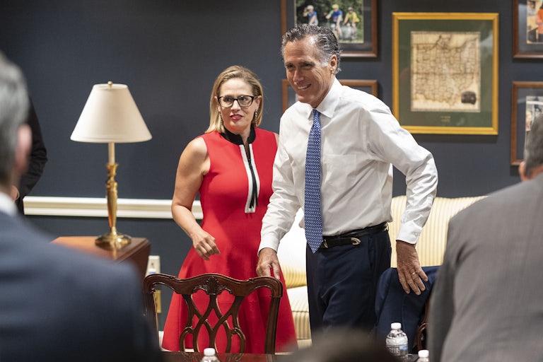 Kyrsten Sinema and Mitt Romney at a meeting in June