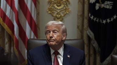 Donald Trump presses his lips together while sitting in the Cabinet Room at the White House