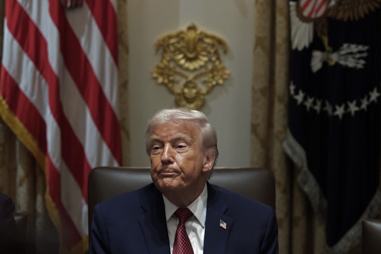 Donald Trump presses his lips together while sitting in the Cabinet Room at the White House