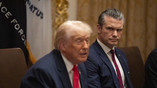 Donald Trump speaks while sitting next to Pete Hegseth