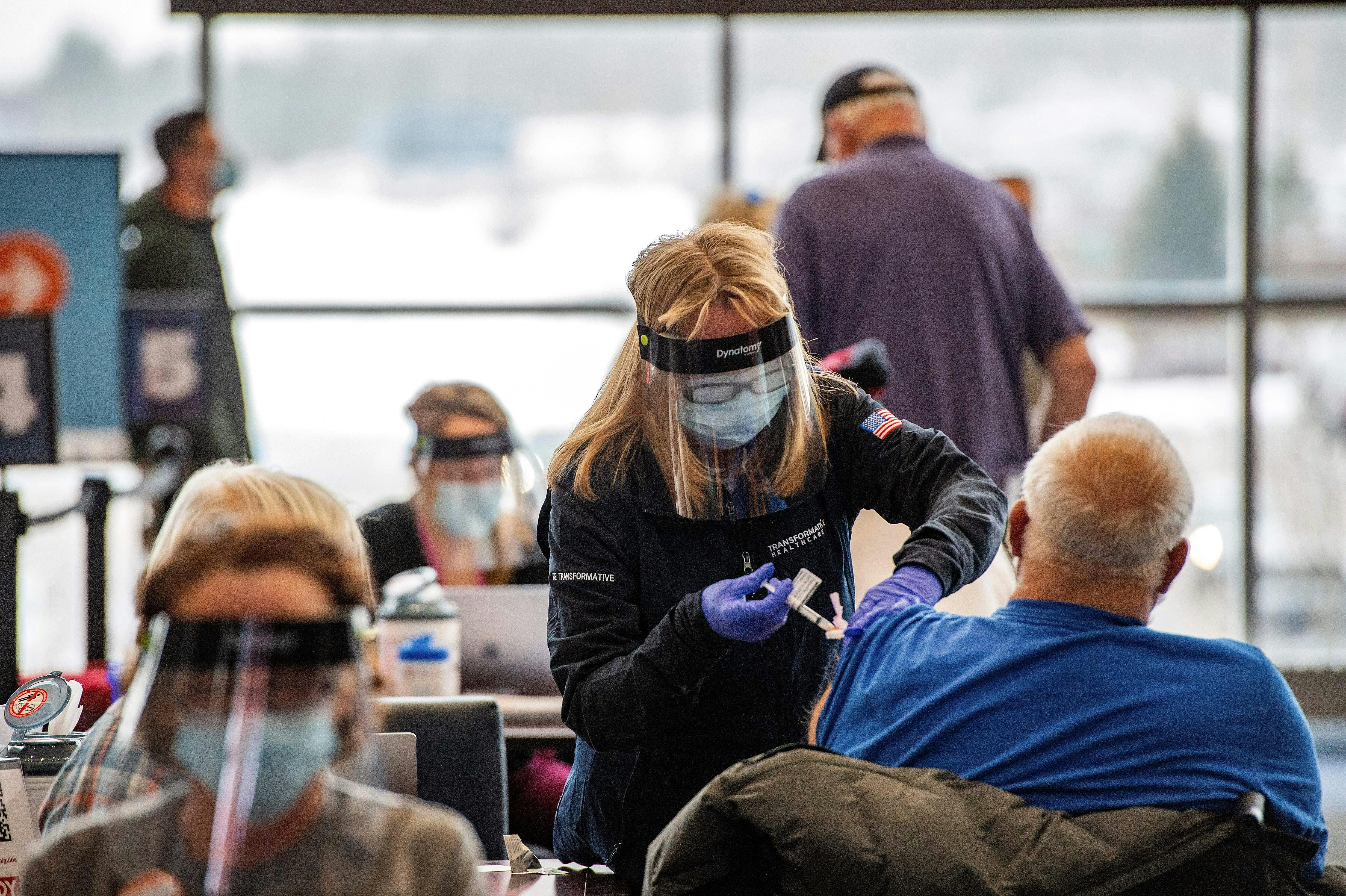A health worker administers the Covid vaccine.