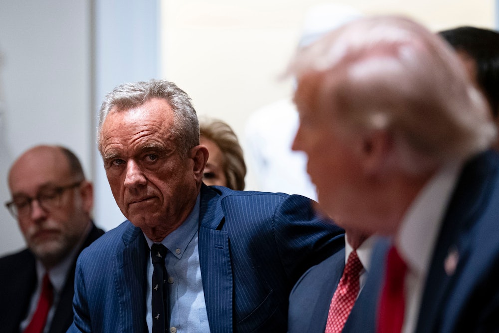 RFK Jr. look at Trump, who is talking.