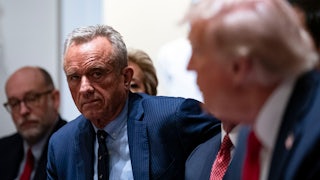 RFK Jr. look at Trump, who is talking.