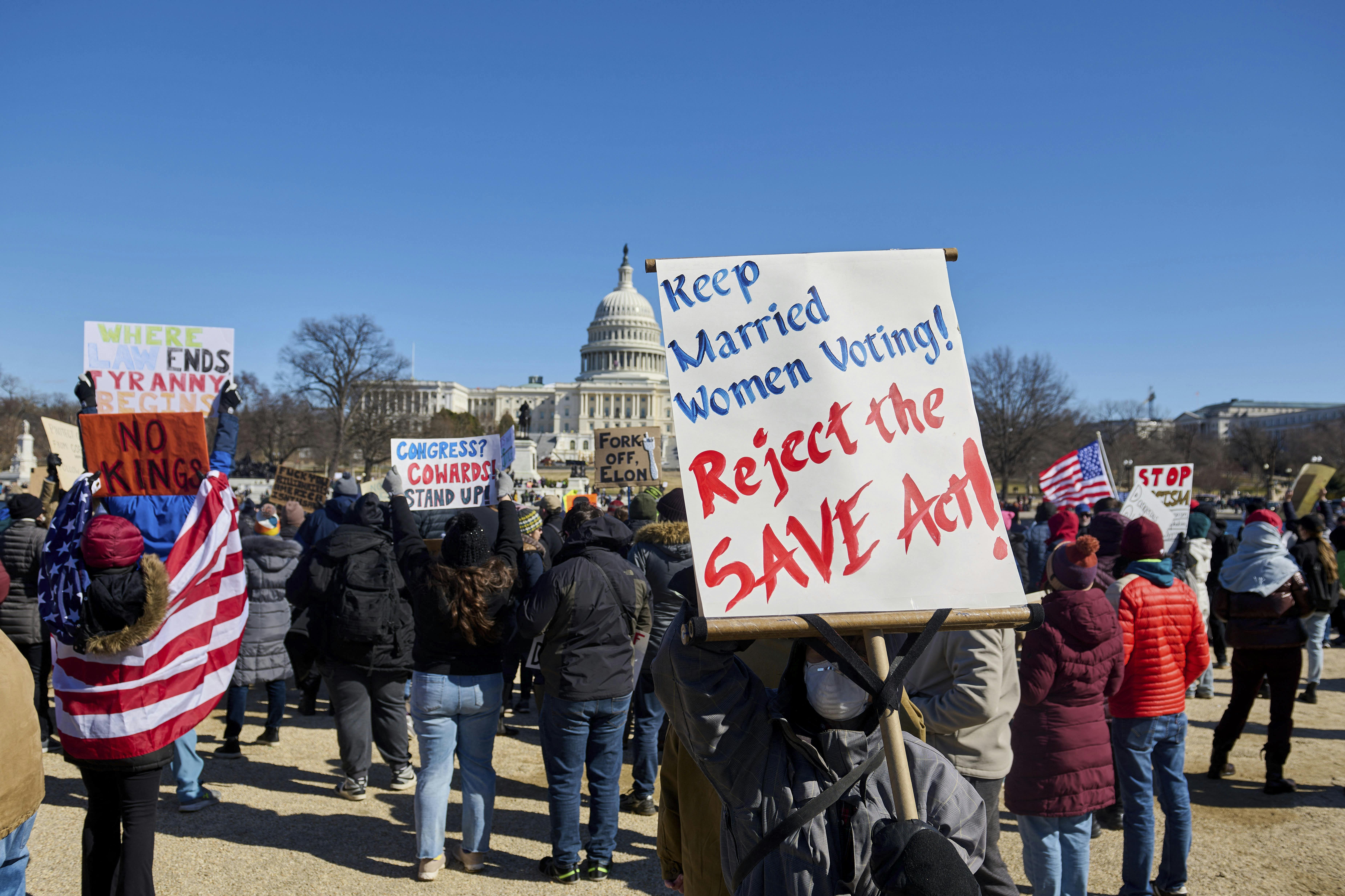 People participate in a protest against the Trump administration's mass firing of government workers and civil servants in front of the Capitol building in Washington D.C. on Presidents' Day, Feb. 17, 2025. 