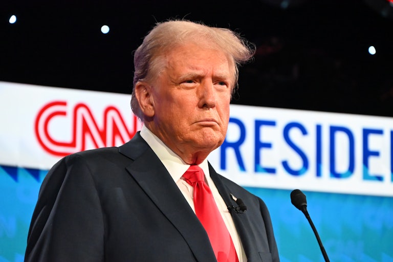 Donald Trump stands in front of a microphone