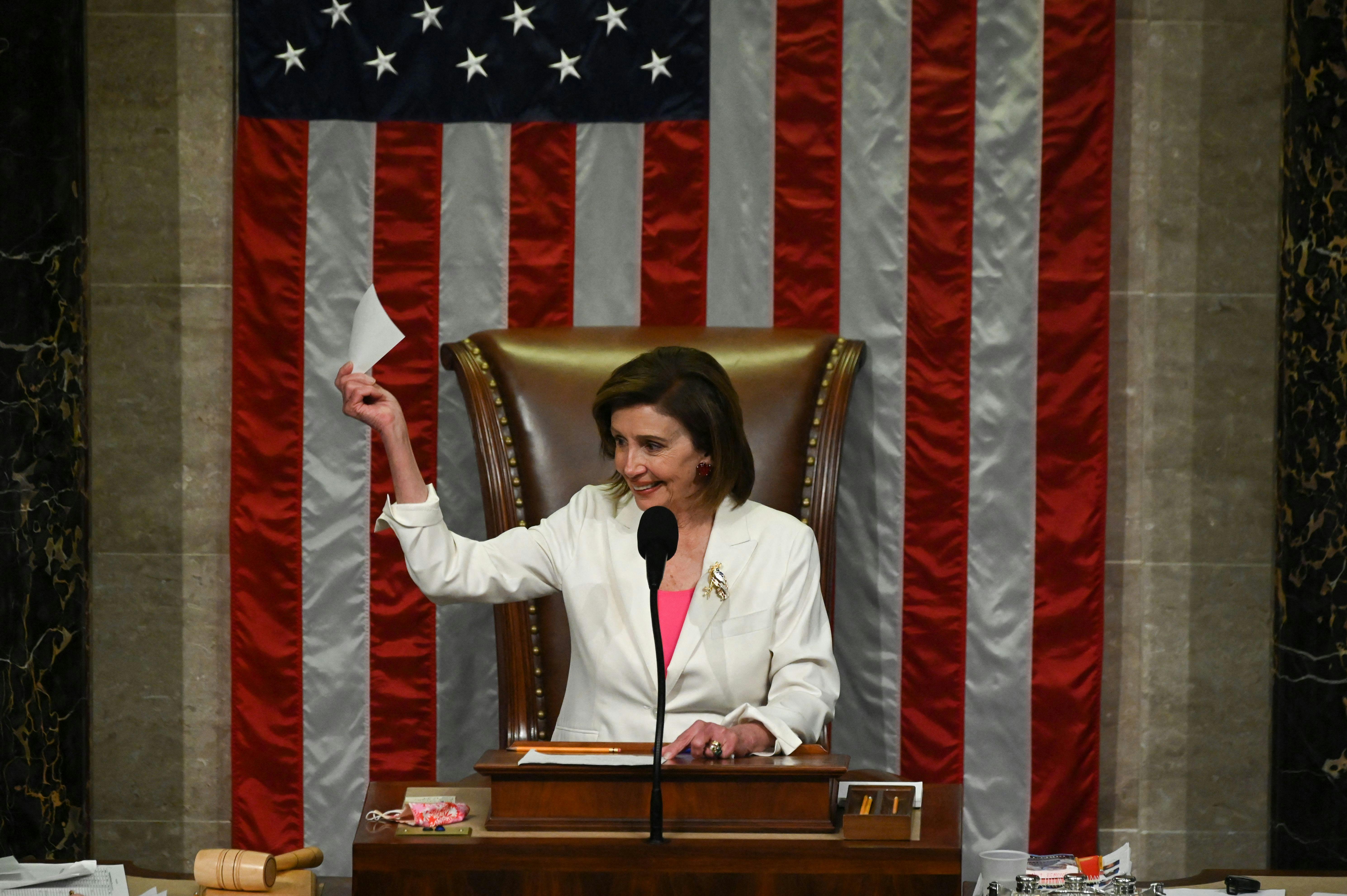 Speaker of the House Nancy Pelosi celebrates the passing of the Build Back Better Act.