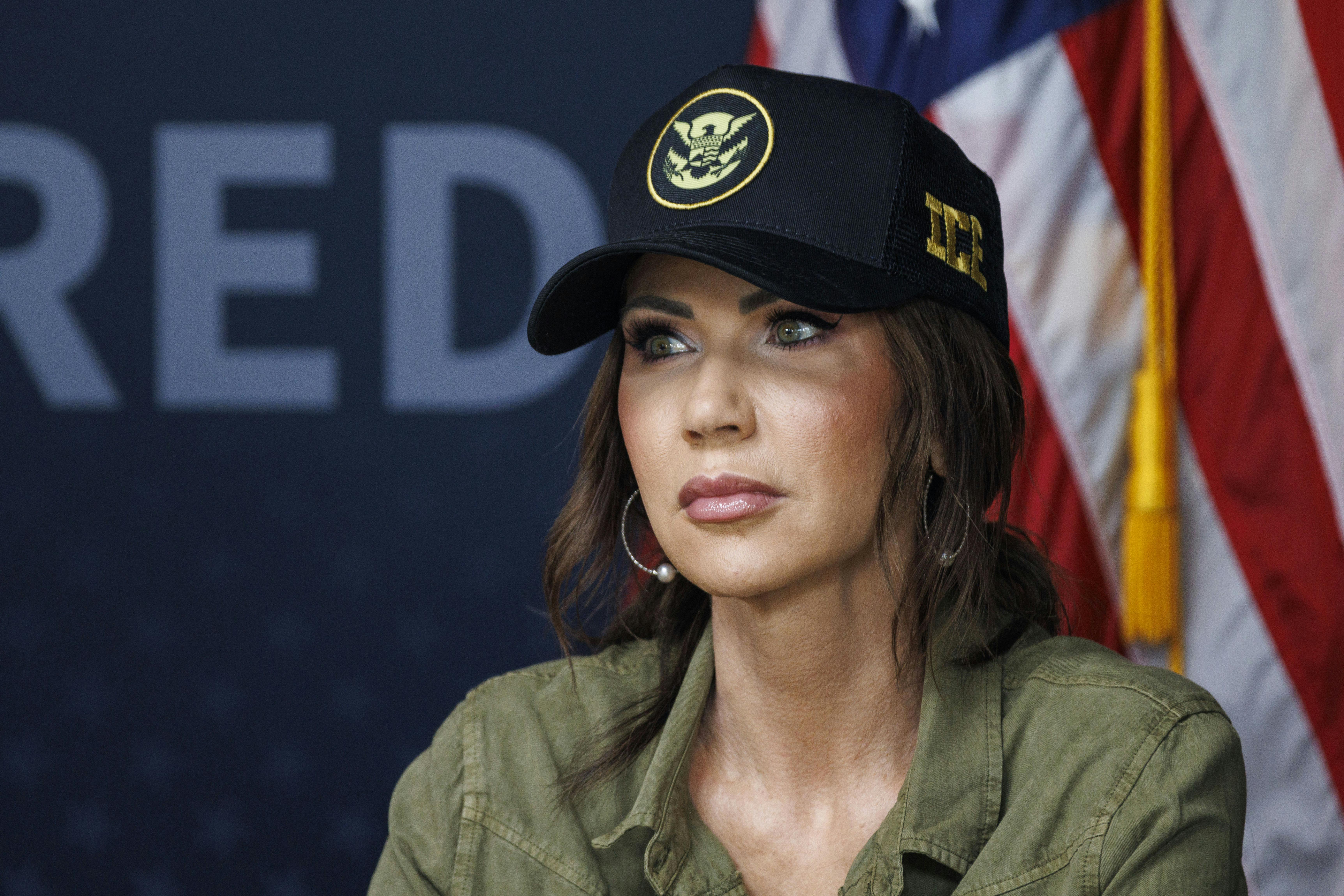 Homeland Security Secretary Kristi Noem wearing an ICE hat
