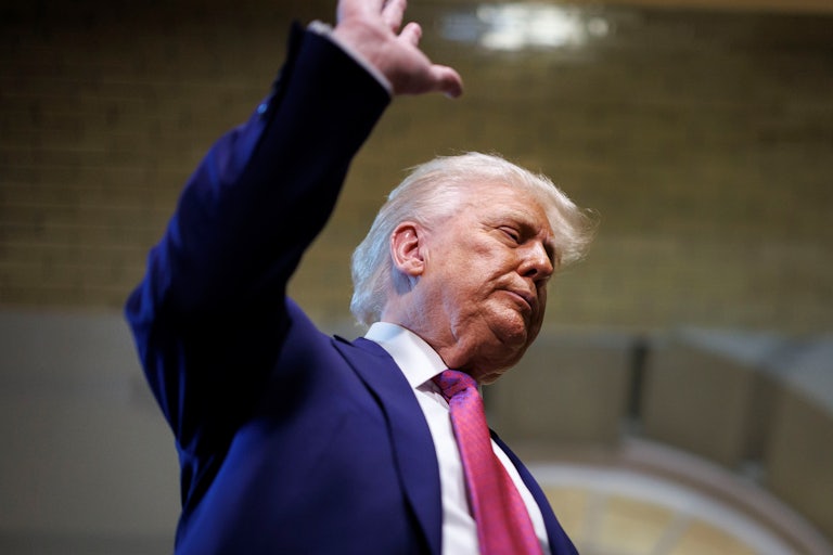 Donald Trump waves while standing outside the U.S. Capitol