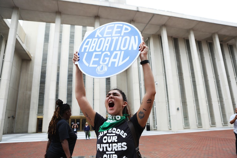 A woman holds a pro-abortion protest sign