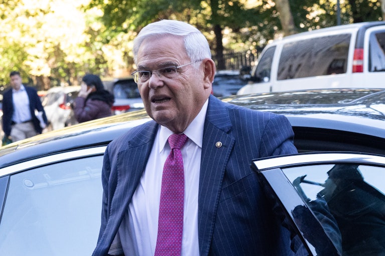 Bob Menendez leaves a car