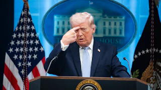Trump points at forehead