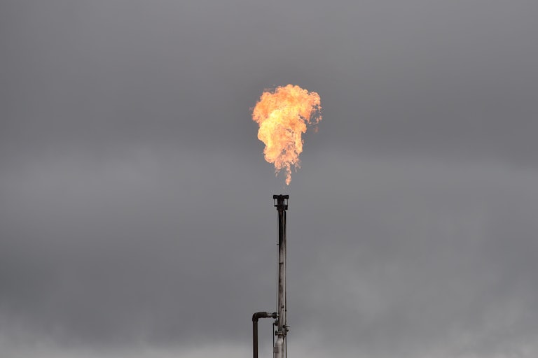 Gas is burned off from an oil well.