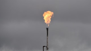 Gas is burned off from an oil well.
