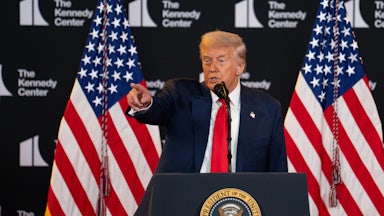 Donald Trump points while speaking behind the presidential podium at the Kennedy Center.
