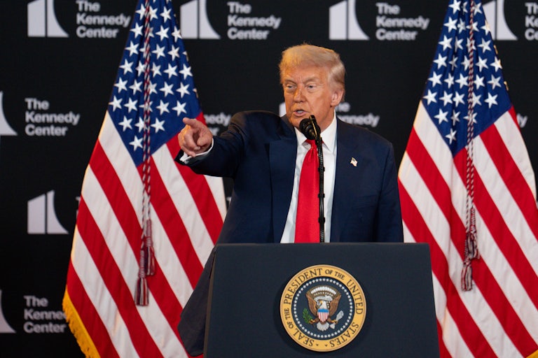 Donald Trump points while speaking behind the presidential podium at the Kennedy Center.