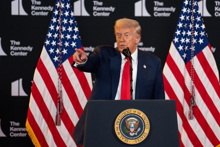 Donald Trump points while speaking behind the presidential podium at the Kennedy Center.