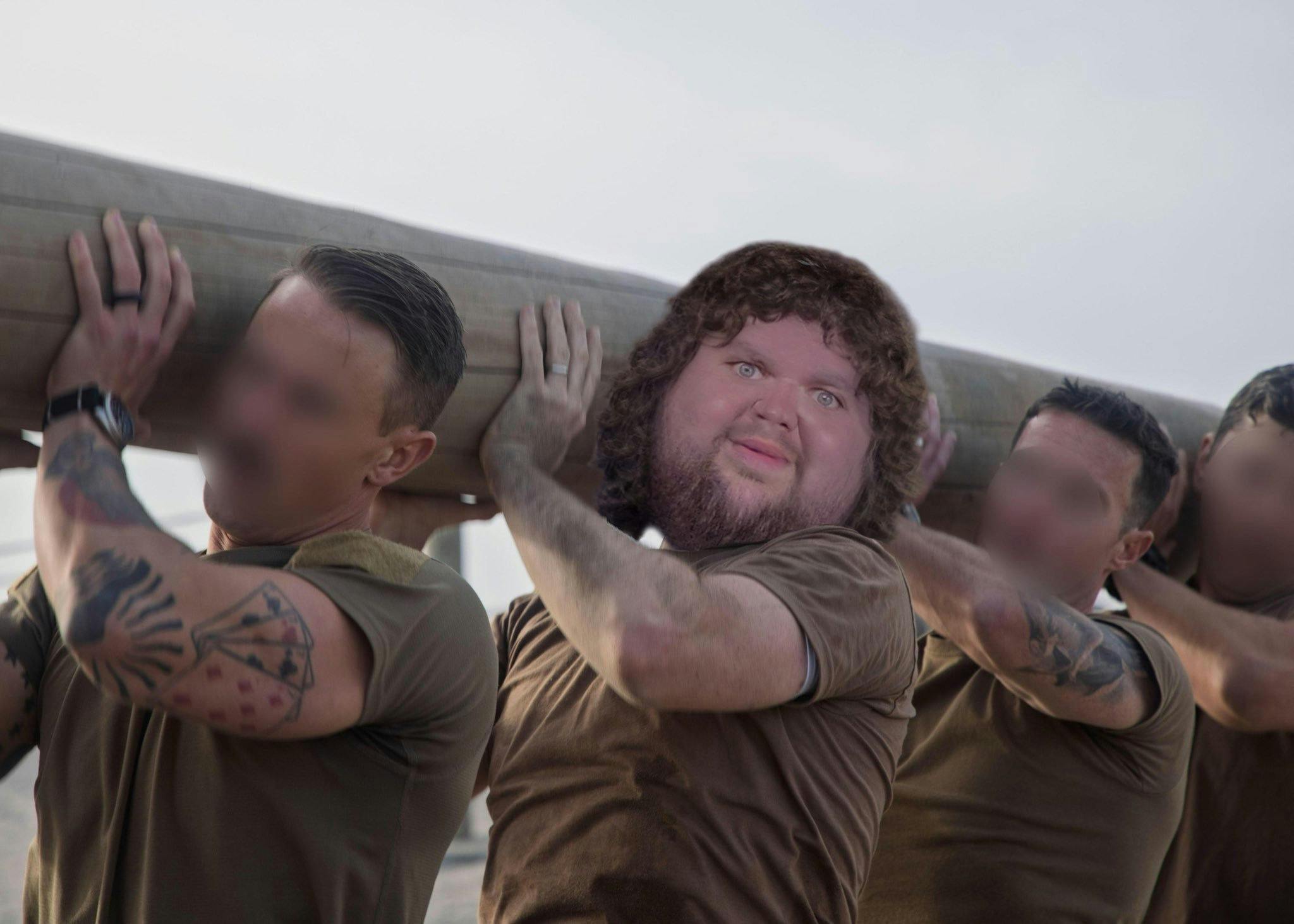 JD Vance meme head posted on his body as he trains with three other Navy Seals, all holding up a giant log.