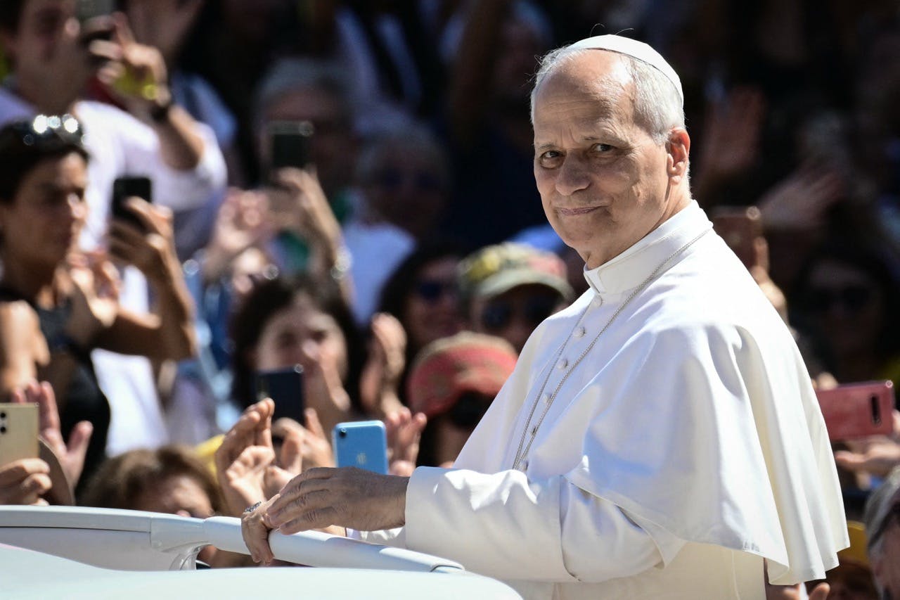 Pope Leo XIV greets the crowd from the popemobile