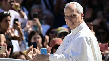 Pope Leo XIV greets the crowd from the popemobile