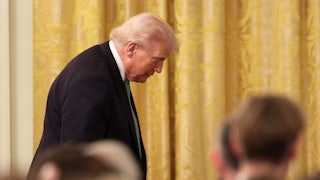 Donald Trump, seen in profile, looks down during an event