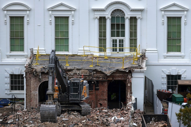 An excavator sits on the rubble after the East Wing of the White House was demolished.