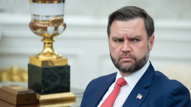 Vice President JD Vance frowns while sitting in the Oval Office.