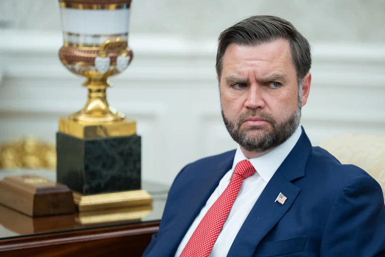 Vice President JD Vance frowns while sitting in the Oval Office.