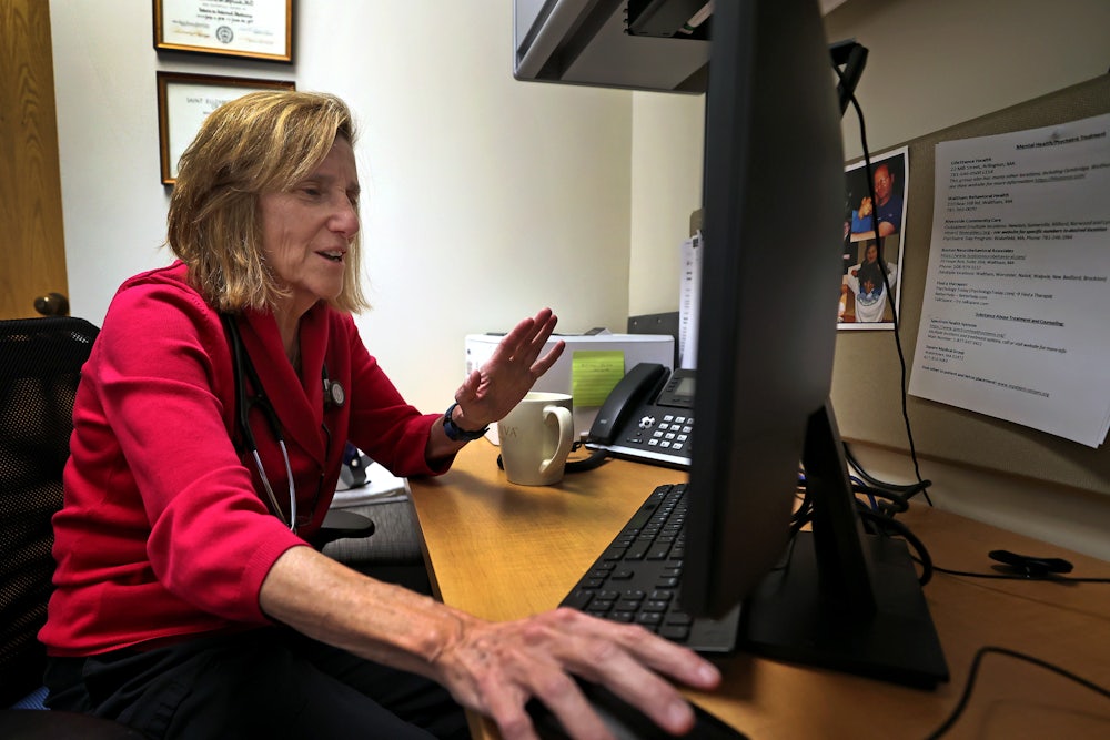 Dr. Barbara Spivak, a primary care doctor, conducts a tele-health session with a patient.