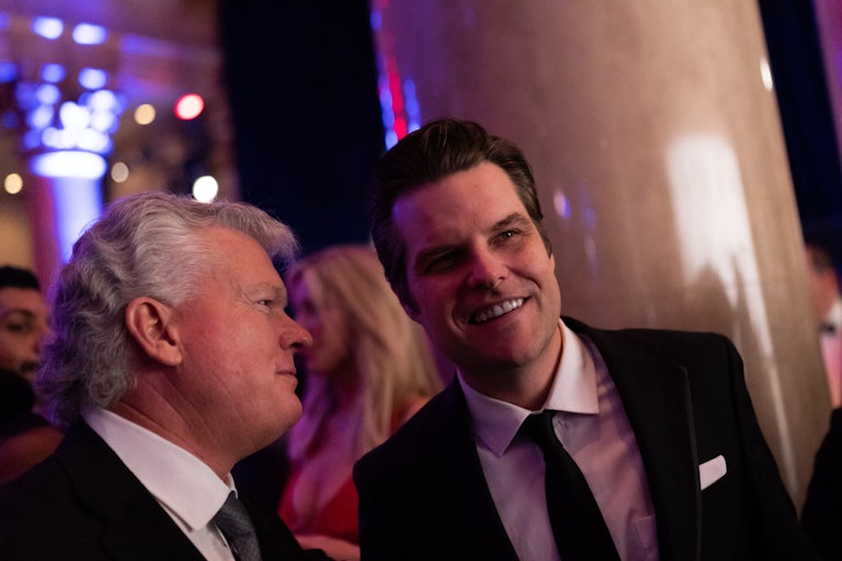 Matt Gaetz smiles while conversing with another person.