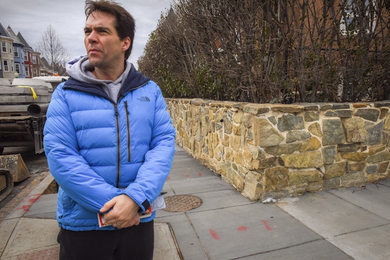 Jack Burkman stands on a street corner