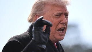 Donald Trump speaks vehemently while holding up right hand