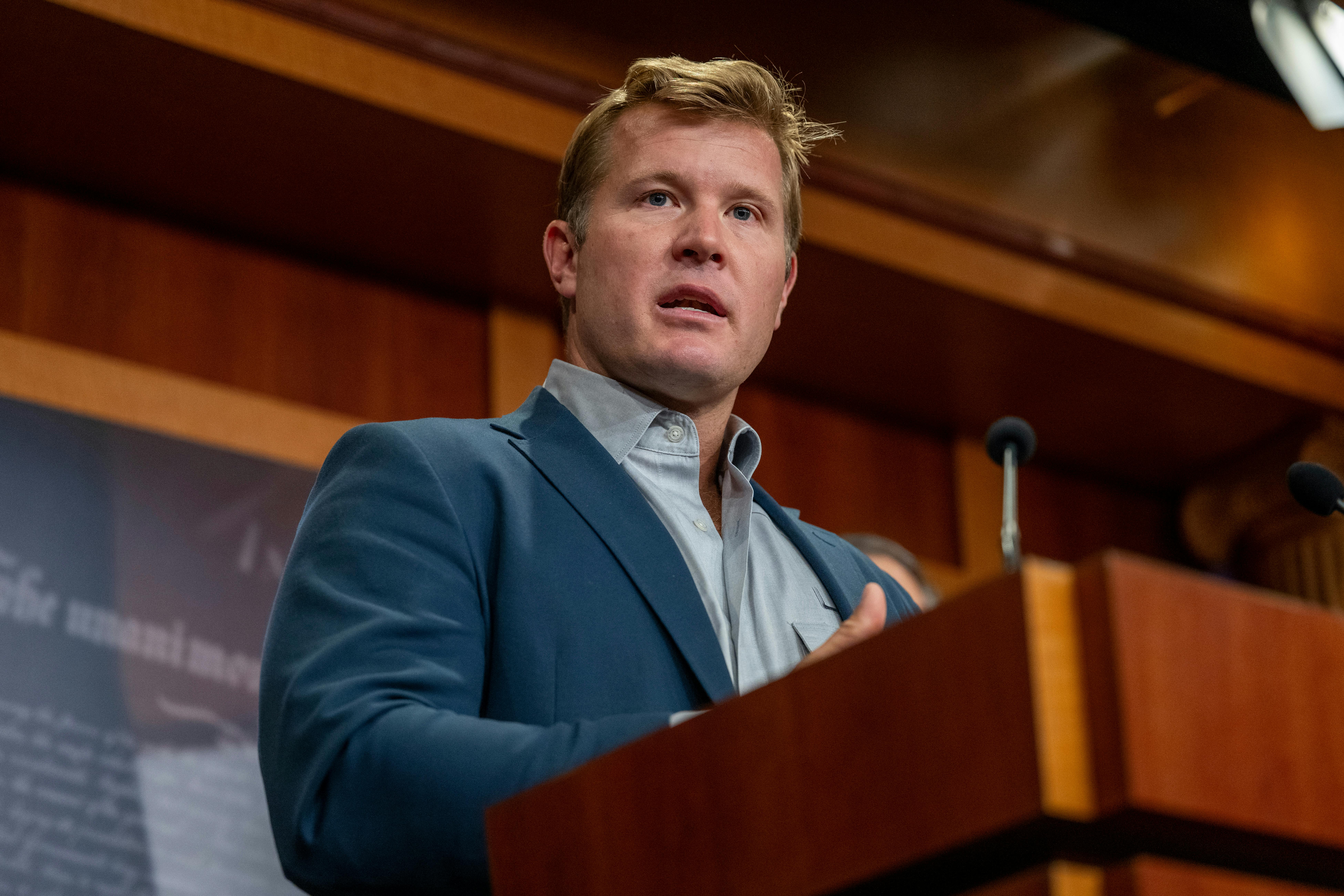 Senator Tim Sheehy speaks at a podium during a press conference
