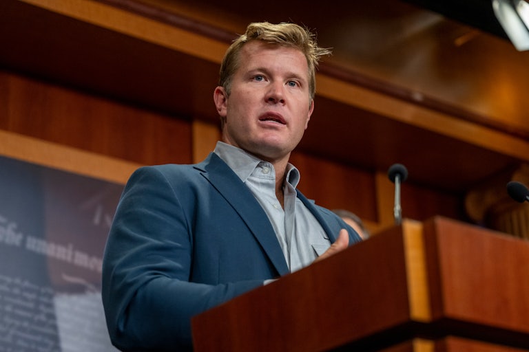 Senator Tim Sheehy speaks at a podium during a press conference