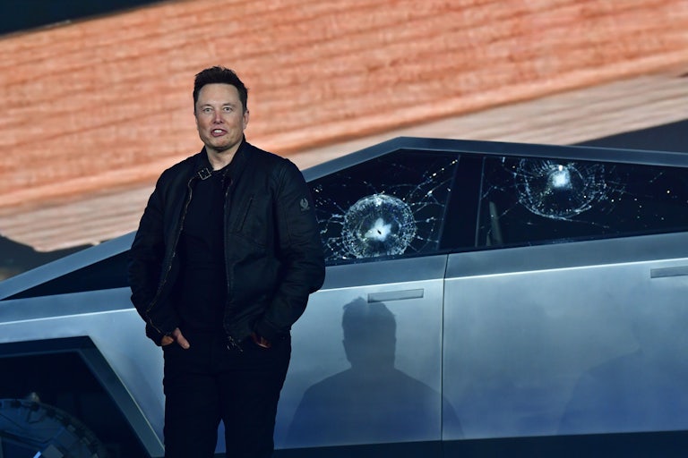 Elon Musk awkwardly stands in front of a Cybertruck whose windows have been repeatedly smashed. They didn't break but that's kind of bad? Sometimes you need to get out of the car.