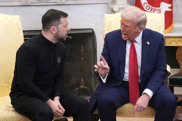 Donald Trump raises his finger and speaks to Ukrainian President Volodymyr Zelenskiy as they sit in the Oval Office