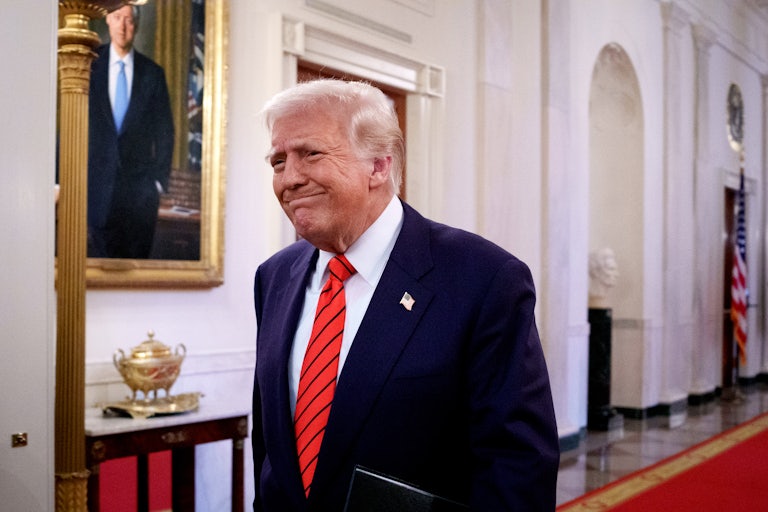 Donald Trump frowns while walking in the White House