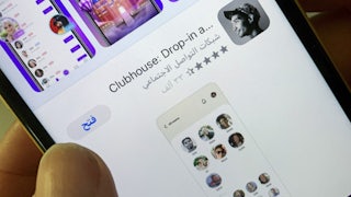 A woman checks the Clubhouse App on her phone in the Saudi capital of Riyadh.