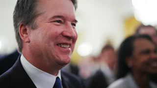 Supreme Court Justice Brett Kavanaugh smiles while walking out of the White House