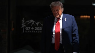 Donald Trump walks out to talk to reporters after signing a trade agreement with British Prime Minister Keir Starmer.