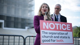 Rev. Shannon Fleck, executive director of Faithful America, speaks as Rev. Paul Brandeis Raushenbush, president and CEO of Interfaith Alliance, listens during a news conference outside the U.S. Supreme Court as it heard oral arguments in a case which could open up public funding for religious schools.