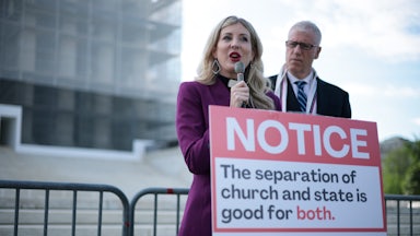 Rev. Shannon Fleck, executive director of Faithful America, speaks as Rev. Paul Brandeis Raushenbush, president and CEO of Interfaith Alliance, listens during a news conference outside the U.S. Supreme Court as it heard oral arguments in a case which could open up public funding for religious schools.