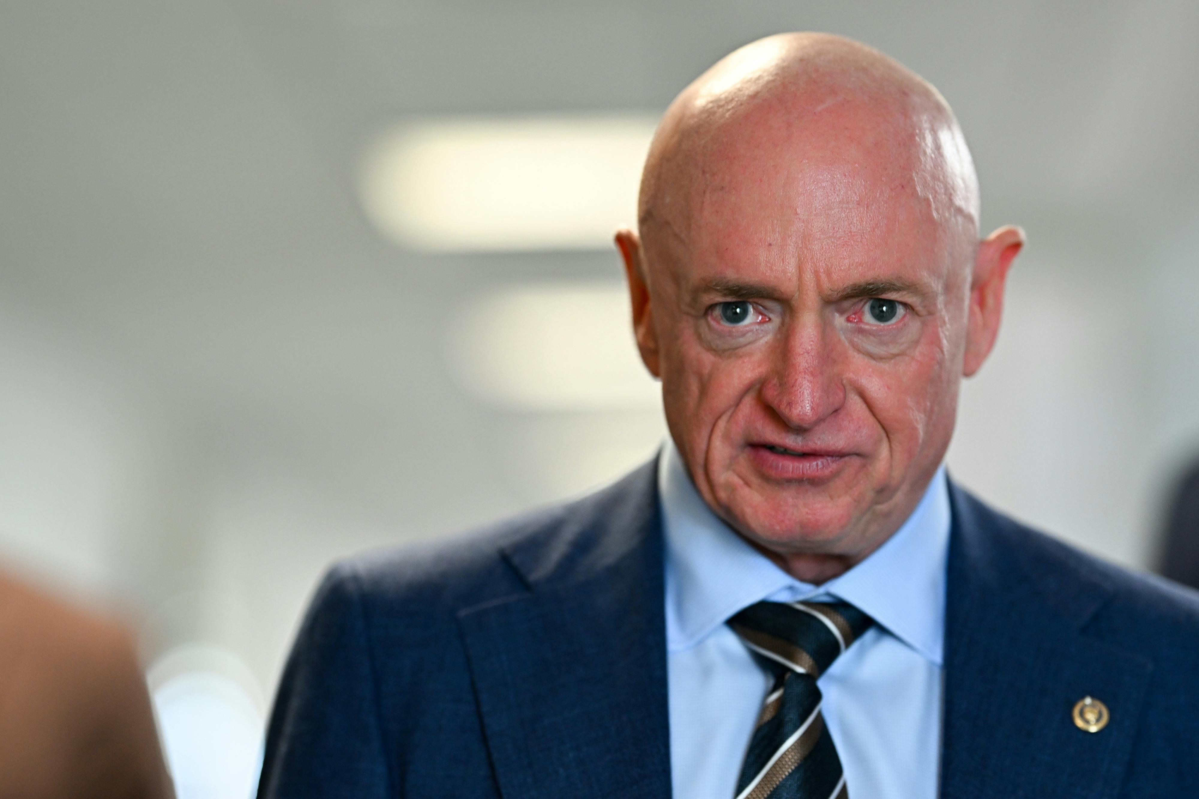 Senator Mark Kelly stares into camera