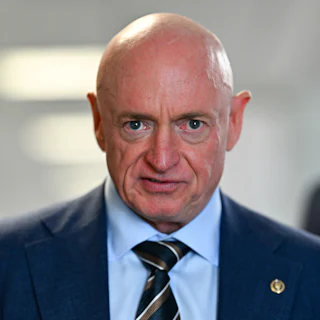 Senator Mark Kelly stares into camera