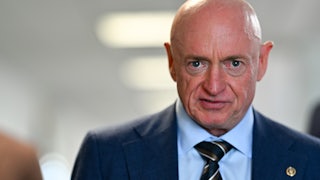 Senator Mark Kelly stares into camera