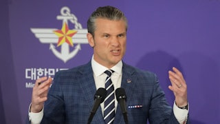 Defense Secretary Pete Hegseth gestures with hands and grimaces