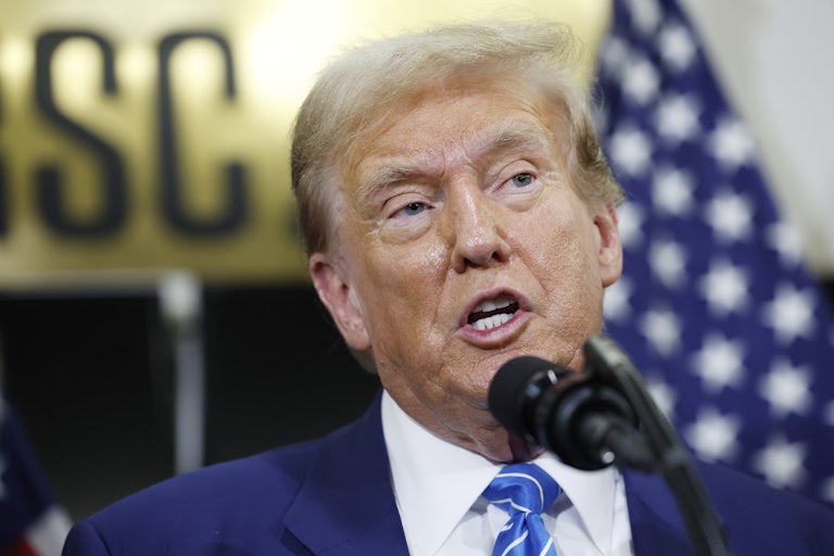 Donald Trump speaks into a microphone