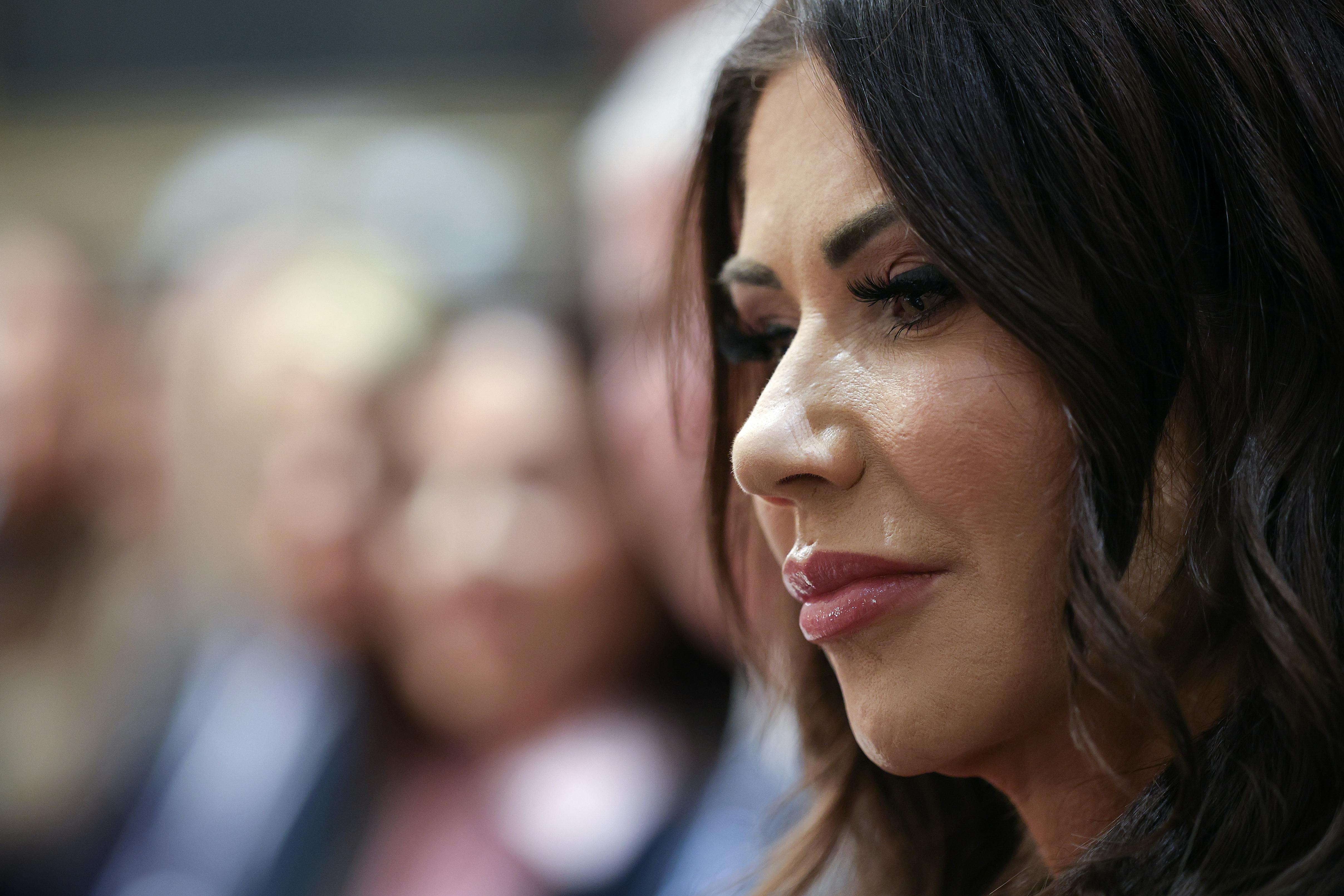 Homeland Security Secretary Kristi Noem looks down while sitting in Donald Trump's Cabinet meeting